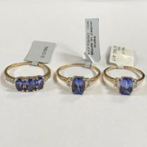 A collection of three Tanzanite and white zircon dress rings. Comprising two Tanzanite solitaire