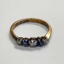 A sapphire and diamond band ring. Marked "18ct Plat" to the shank and tests accordingly. Size P 1/2.