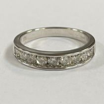 A diamond set 9ct white gold half eternity ring. Featuring nine round brilliant cut diamonds, with a
