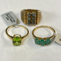 A gentleman's cats eye chrysoberyl dress ring, along with a peridot set solitaire ring and an