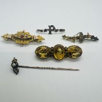 A collection of antique bar brooches. Featuring a Three stone citrine brooch, stamped "15c" and "