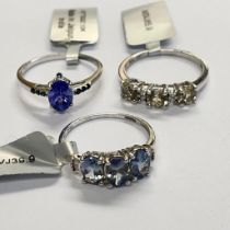 Three 9ct white gold gem set rings. To include a bi-colour tanzanite and diamond set dress ring