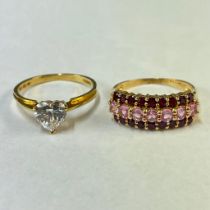 Two 14ct yellow gold gem set rings. Featuring a heart shaped cubic zirconia solitaire ring and a