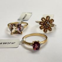 A trio of 9ct yellow gold rings including a Capricorn zircon and diamond ring, a Malawi garnet and