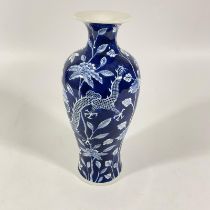 A 20th century Chinese blue and white Chinese vase decorated with two dragons and flowering trees.