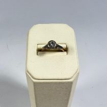 An 18ct yellow gold diamond solitaire diamond ring, rubover set, approximately 5mm wide, ring size