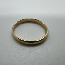 A yellow metal band D-shaped band ring. Size R. Tests as 22ct gold. Approximate weight 2.4 grams