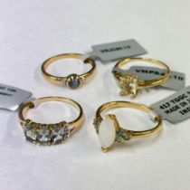 A collection of four 9ct yellow gold gem set rings. To include a distinctive marquise cut opal dress