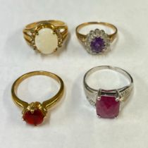 An amethyst and diamond ring in 9ct yellow gold along with three other gem set rings in 9ct gold. To