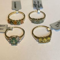 A collection of four 9ct yellow gold gem set rings. Including two with accenting  diamonds. Size R