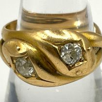 A Victorian double serpent head 18ct gold and diamond ring. Set with two old mine cut diamonds