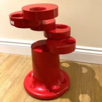 A red rotating plastic pluvium umbrella stand by Giancarlo Piretti for Anonima Castelli.  49cm tall.