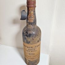 A 1963 bottle of Alto Douro Borger Oporto vintage port. Some wear to seal but appears intact, good
