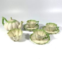 A set of Belleek China comprising a tea pot, three cups, five saucers and a sugar bowl.