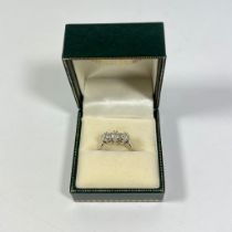 An 18ct white gold 3 stone diamond ring, size M. Centre diamond approximately .35ct.  3.8 grams.