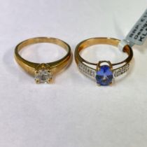 A Tanzanite and diamond set ring, along with a white Zircon solitaire ring, both in 9ct yellow gold.