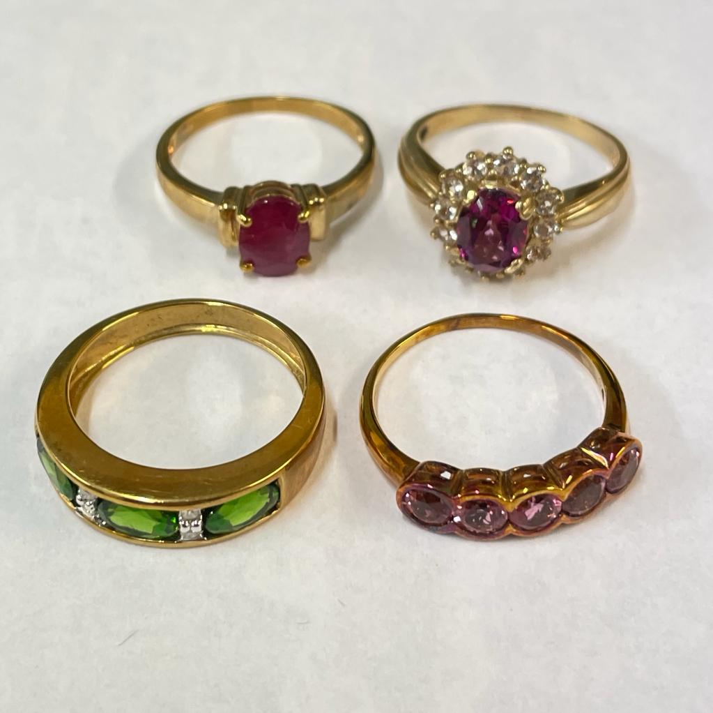 A collection of four gem set 9ct gold rings. Featuring a filled ruby solitaire and a diamond and