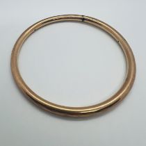 A hallmarked 9ct gold wax filled bangle. Internal diameter approximately 7.5 cm. Approximate gross