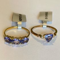 Two 9ct yellow gold tanzanite rings, one a trilliant cut solitaire with two accenting diamonds,