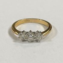 A 9ct yellow gold diamond set trilogy ring. Featuring a central stone of an estimated 0.40 carats,