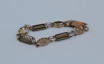 A 9ct marked precious yellow metal Chinese character and abacus bracelet. Gross weight approximately