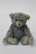 Steiff, a late 20th century fully jointed teddy bear, with brown eyes, powder blue mohair fur and