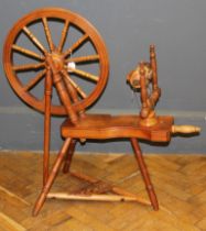 A 20th century beech spinning wheel, of traditional twelve spoke form. Maximum height 90cm