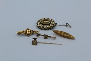 A collection of gold brooches, featuring two Victorian revival brooches in 9ct gold, a modernist 9ct