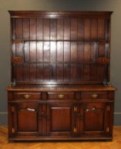 A Titchmarsh and Goodwin oak tall dresser, the rack with open shelves and two spice drawers, the