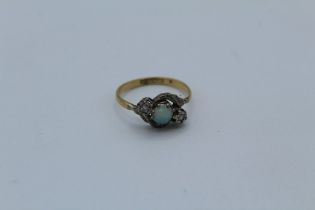 An opal and diamond set ring stamped 18ct and Plat to the shank