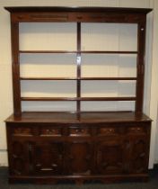 An 18th century oak tall dresser, the geometrically moulded rack with three open shelves, the base