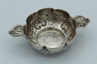 Stuart Clifford, a Victorian silver quaich of twin handled demi-lobed form set with 1711 Queen