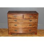 A George III mahogany bow front chest of two short and three long drawers with brass drop handles,