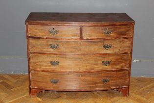 A George III mahogany bow front chest of two short and three long drawers with brass drop handles,