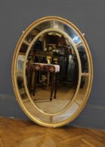 A 19th Century gilt gesso wall mirror, the beaded egg and dart moulded frame applied with stiff