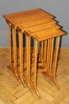 A 20th century satinwood quartetto of nesting occasional tables, each raised on turned supports