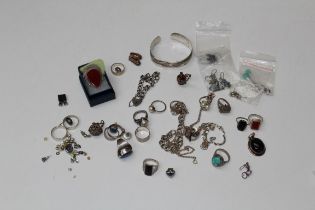 A collection of silver jewellery comprising seventeen rings, six pairs of earrings, pendants, bangle