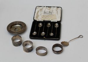 Gladwin Ltd, a cased set of six silver bean terminal coffee spoons, four silver serviette rings, a