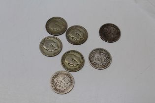 Seven One Shilling Coins including four George V and three Queen Victoria