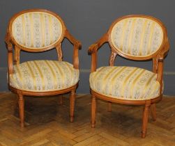 A pair of 20th century Regency stripe upholstered open spoon back armchairs in the French manner,