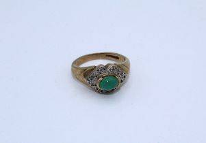 A 9ct yellow gold emerald and diamond dress ring, size J. Weight 3.8gm approximately