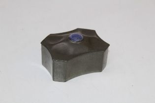 A Liberty and Co pewter hinged box and cover, of rectangular form with canted corners and concave