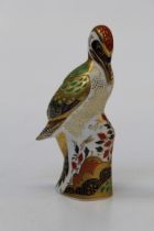 A Royal Crown Derby Green woodpecker paperweight with gold stopper, 17cm