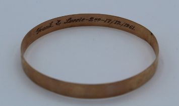 A 9ct stamped bangle in yellow metal ( tests as 9ct gold) engraved inside. Approximate weight 23.