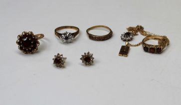 A collection of garnet and red stone jewellery in 9ct gold. Comprising four rings, a pair of cluster