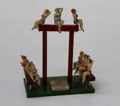 A small 1950's plastic and perspex moulded display stand applied with bathing beauties around a
