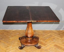 A Victorian rosewood supper table, the rectangular folding swivel top on an octagonal baluster