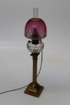 A Victorian paraffin table lamp with facet cut clear glass reservoir, brass Corinthian column and