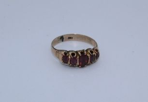 A closed back set garnet half hoop ring. Stamped 9ct to shank, size O, gross weight approximately