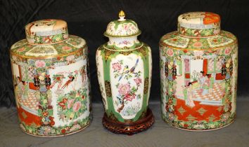A pair of modern Chinese cylindrical jars and covers painted with with figures, flowers and symbols,